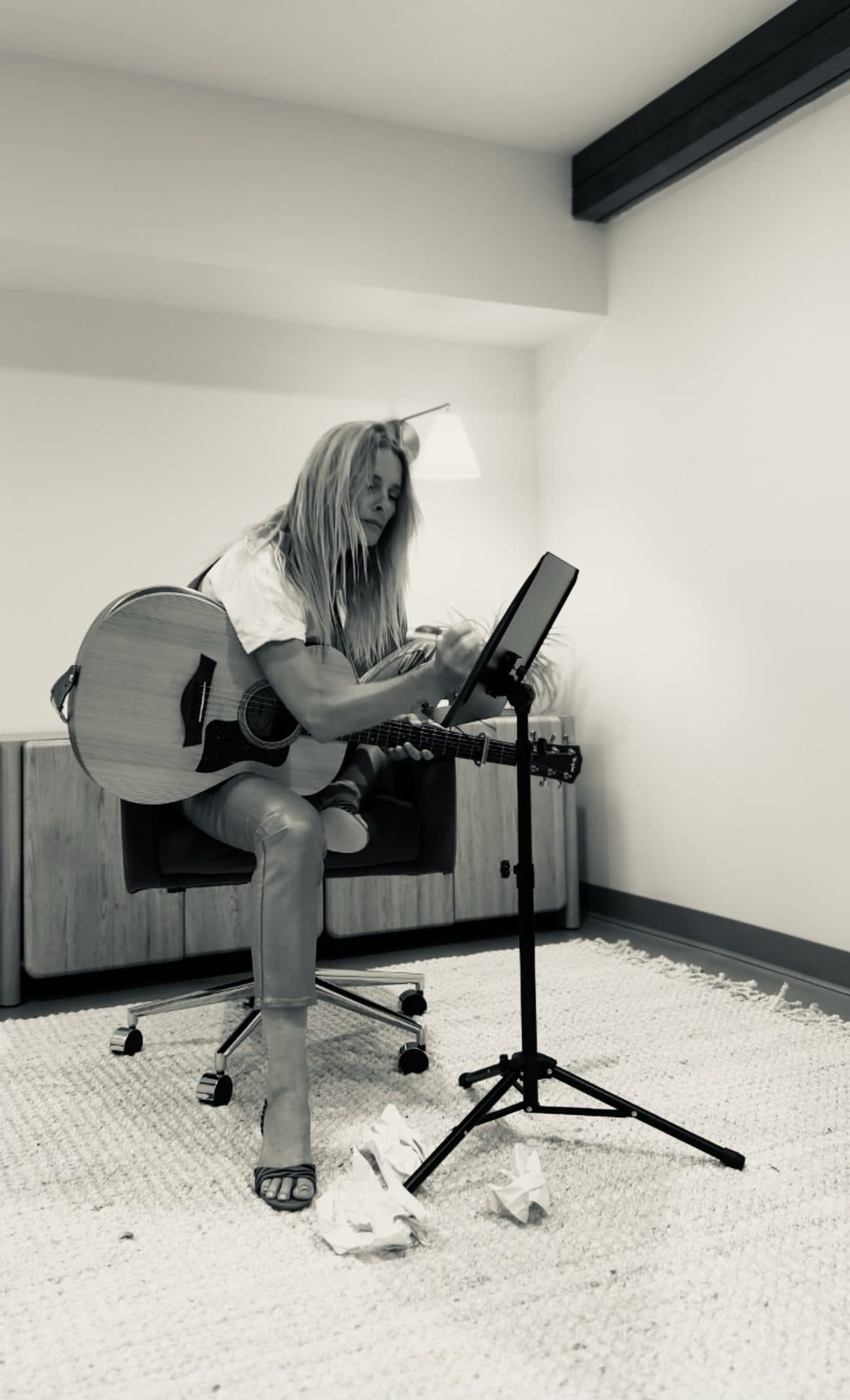 Rachel Engelhorn playing guitar in a home studio